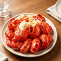 Cooked crawfish piled on a white serving plate