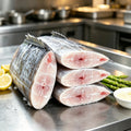 Ribbonfish segments on a steel tray with lemon